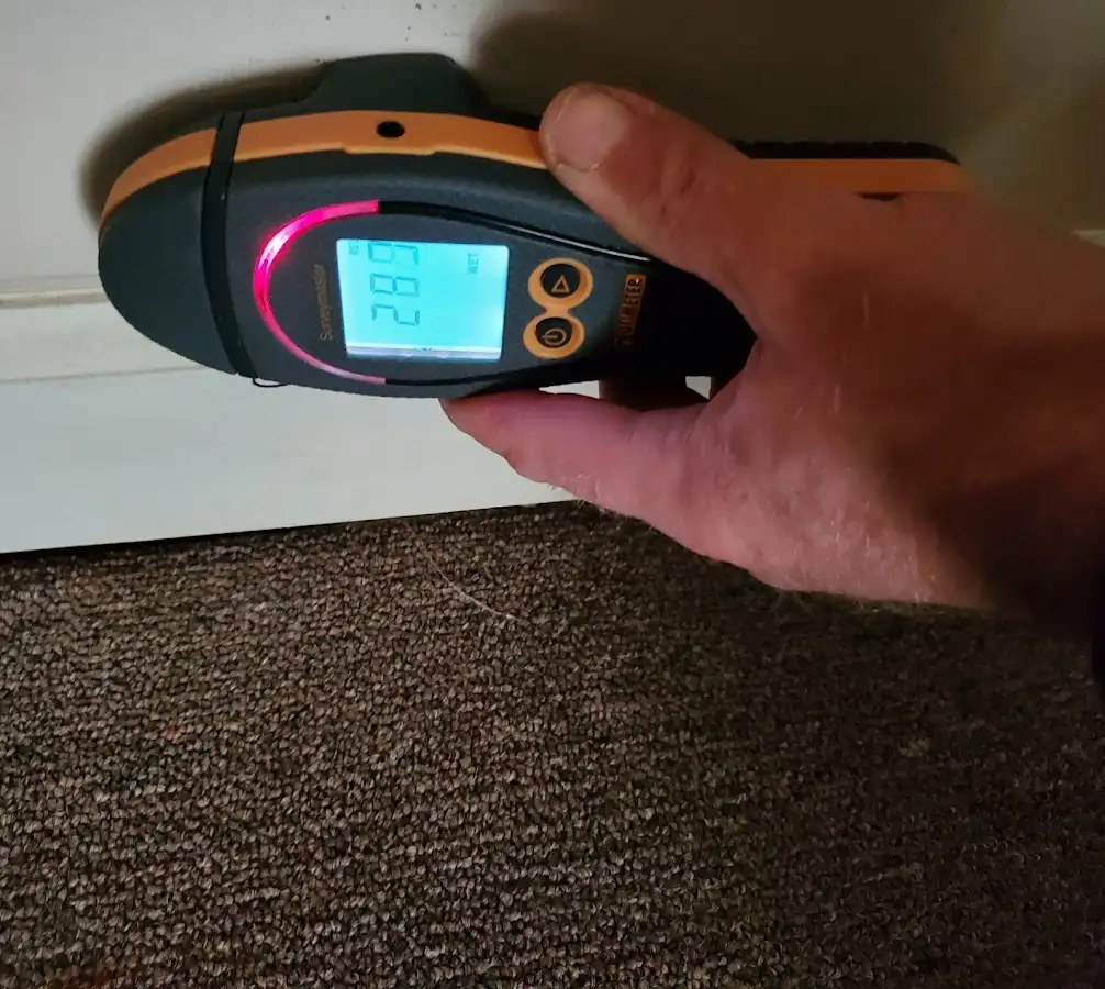 Moisture detection at baseboard during Storm Damage Restoration in Flagstaff
